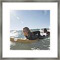 Young Man Being Towed In Sea By Young Woman On Surfboard, Smiling Framed Print