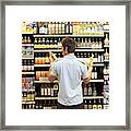 Young Man In Supermarket Comparing Bottles Of Oil, Rear View, Close-up Framed Print