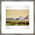 Emirates B777-300er Landing At A Wet Framed Print
