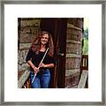 Female Flute Player At Log Cabin Framed Print