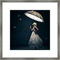 Girl With Umbrella And Falling Feathers Framed Print