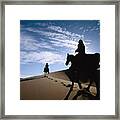 Horseback Riders In Silhouette On Sand Framed Print