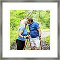 Older Couple Kissing In The Woods While Trekking Framed Print