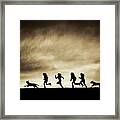 Silhouettes Of Running Girls And Dogs Framed Print