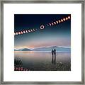 Woman And Girl Standing In Lake Watching Solar Eclipse Framed Print