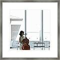 A Female Cellist Making Herself At Home Framed Print