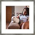 A Little Girl Strokes Her Pet At Home Framed Print