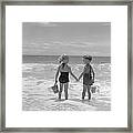 Boy And Girl Standing On Beach, Holding Framed Print