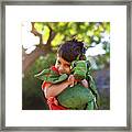 Boy Embracing Stuffed Toy At Park Framed Print