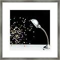 Confetti Floating Next To A Table Lamp Framed Print