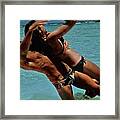Couple Playing In The Sea Framed Print