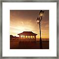 Cromer Pier In Norfolk England Shelter At Sunset Framed Print