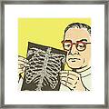 Doctor Looking At An X-ray Framed Print