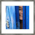Face Behind Blue Door Framed Print