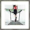 Mixed Race Woman Running On Treadmill Framed Print