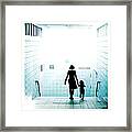 Mother And Child Walking Through Urban Framed Print
