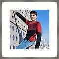 Portrait Of A Teen Hanging Up On Wall While Looking To Camera Framed Print