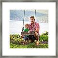 Portrait Of Father And Son Holding Rope Swing At Lakeshore Framed Print