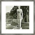 Portrait Of Young Woman By Lounge Chair Framed Print