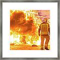 Silhouette Of Fireman Trying To Control A Fire In A Street Durin Framed Print