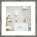 Still Life Of Paper Note With Pastel Coloured Flower Heads And Petals, Overhead View Framed Print