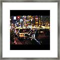 Taxis On Street At Night Framed Print