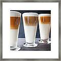 Three Glasses Of Latte Macchiato On Table Framed Print