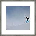 Woman Carrying Skis Walking Up Snow Framed Print