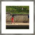 Woman In Orange, With Cell Phone And Umbrella Framed Print
