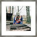 Woman Sat By A Campfire Wrapped In A Blanket In The Forest In Sweden Framed Print