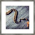 Wooden Rosary Laying On Stone Background. Framed Print