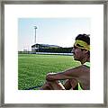 Young Guy In Sportswear Sitting On The Grass Framed Print