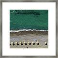 Aerial View From A Flying Drone Of Beach Umbrellas In A Row On An Empty Beach With Braking Waves. Framed Print