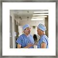 Doctors Talking In Hospital Corridor #1 Framed Print