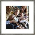 Family Sitting Together In Sofa With Their Dogs Framed Print