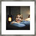 Portrait Of Smiling Woman Relaxing On Couch At Home In The Evening #2 Framed Print
