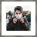 Young Adult Man Wearing A Pollution Mask To Protect Himself From Viruses. His Friends Are In The Background. #2 Framed Print