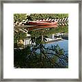 A Red Row Boat Reflecting In Still Waters Framed Print