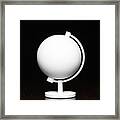 A White Globe On A Desktop Framed Print