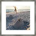 A Woman Catches A Flying Disk Near A Sand Sculpture Of A Fish He Framed Print