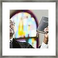 African American Reverend holding up Bible Framed Print