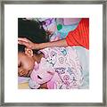 Afrolatina Girl In Pajamas Holding Stuffed Unicorn With Her Eyes Closed. Mother's Face And Neck Not Visible. Mother's Hand On Daughters Head. Framed Print