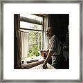 An Old 97-year-old Man Stands At An Open Window In His House And Looks Into The Distance. Framed Print