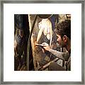 Artist Restoring A Painting In His Studio Framed Print