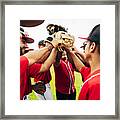 Baseball Team Coach And Players Raising Gloves For High-five Framed Print