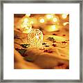 Blurred Golden Christmas Lights With Decorations On Rumpled Bed Framed Print