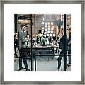 Business Colleagues Brainstorming In Meeting At Office Seen Through Glass Wall Framed Print