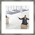 Business Colleagues Inside Cardboard Boxes With Arms Outstretched At New Office Framed Print