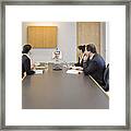 Businesspeople Watching Video Conference In A Conference Room Framed Print