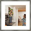 Caucasian Mother Scolding Son On Counter Top Framed Print